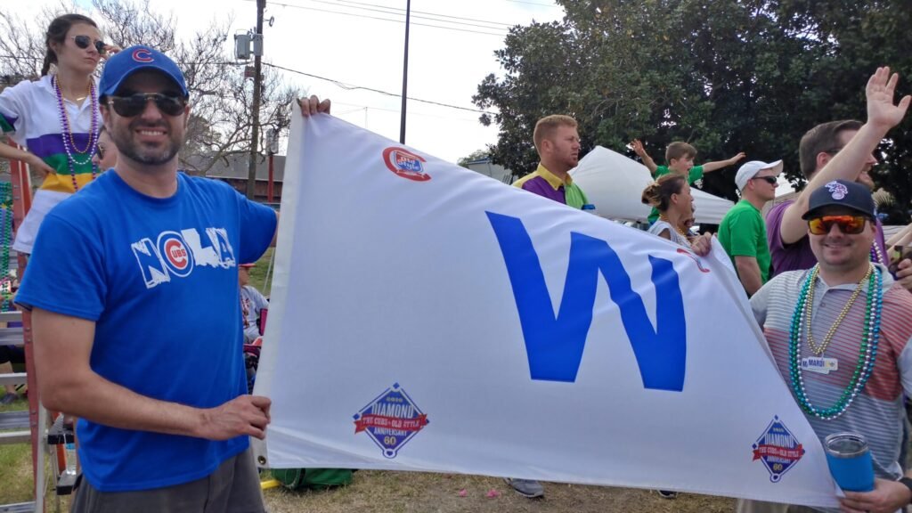 Cubs fans flying the W flag at a Mardi Gras parade
