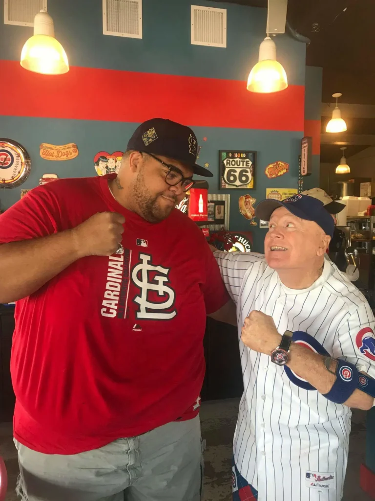 A Cardinals fan and a Cubs fan squaring off at Bruiser's